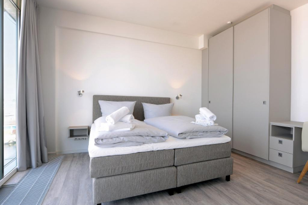 Schlafbereich mit Doppelbett und großem Kleiderschrank