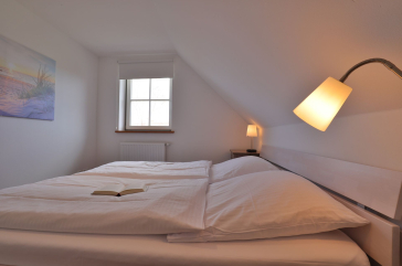 Ruhe-Insel Ferienhaus - Blick in das Schlafzimmer mit einem Doppelbett im OG