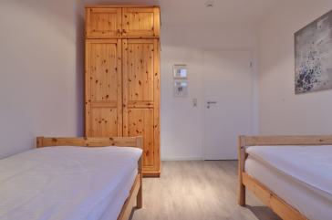 Sünnslag App.13/59 - Blick in das Kinder-/ Gästezimmer mit 2 Einzelbetten