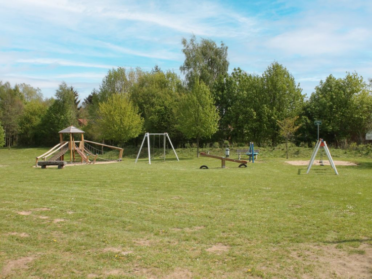 Urlauberdorf  - Blick auf den Spielplatz hinter den Ferienhäusern 54 & 55